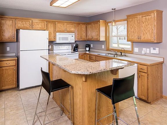 Kitchen features granite bar, appliance garage and a large pantry.