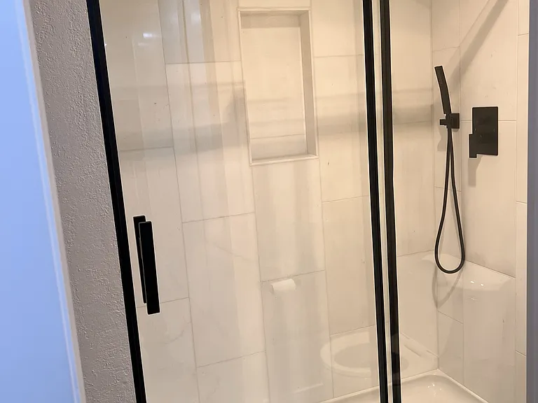 Beautiful walk-in shower with hand wand and overhead spray.