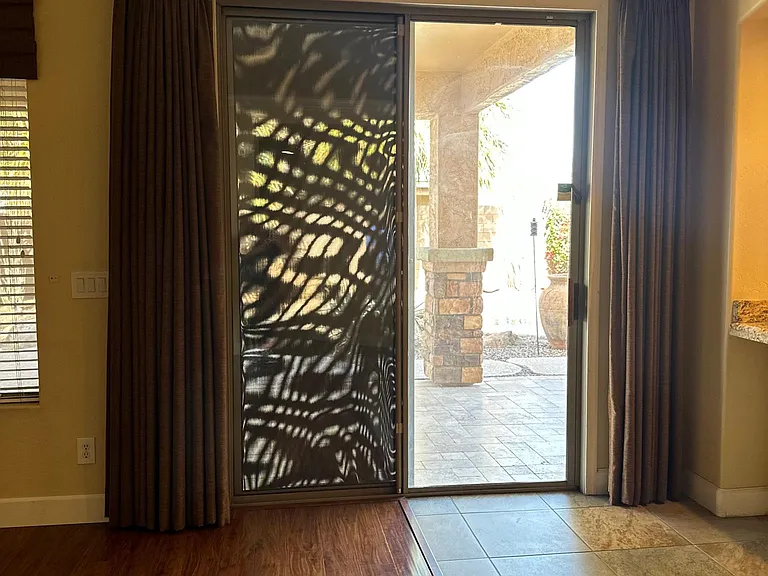 Sliding door comes with custom blackout drapes and screens.
