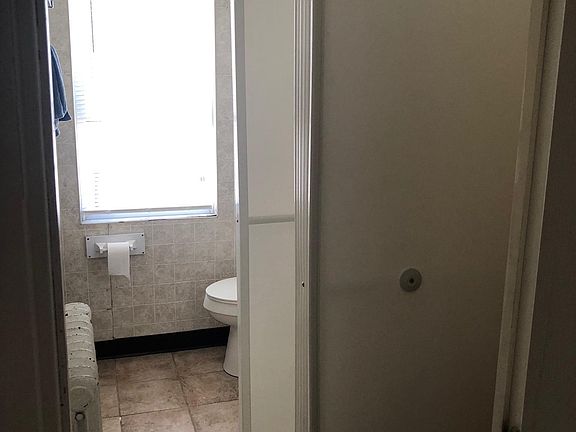 Updated bathroom with tile floor and full shower.