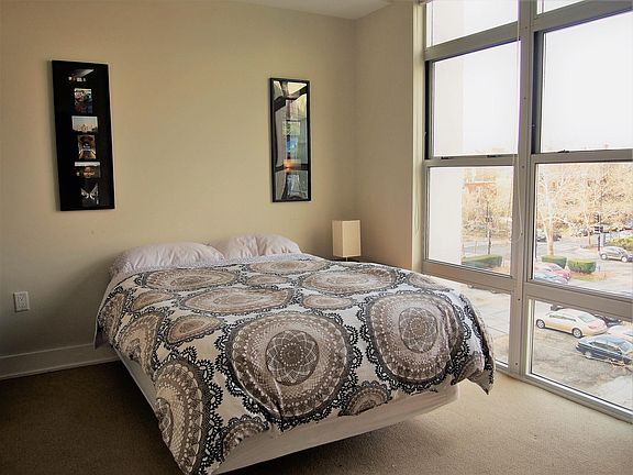 Bedroom with closet, bookshelf, side drawer and lamp