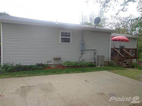 Side of home.  Notice the deck tucked into the side of the house giving ultimate privacy!  This home is the perfect little Cottage!