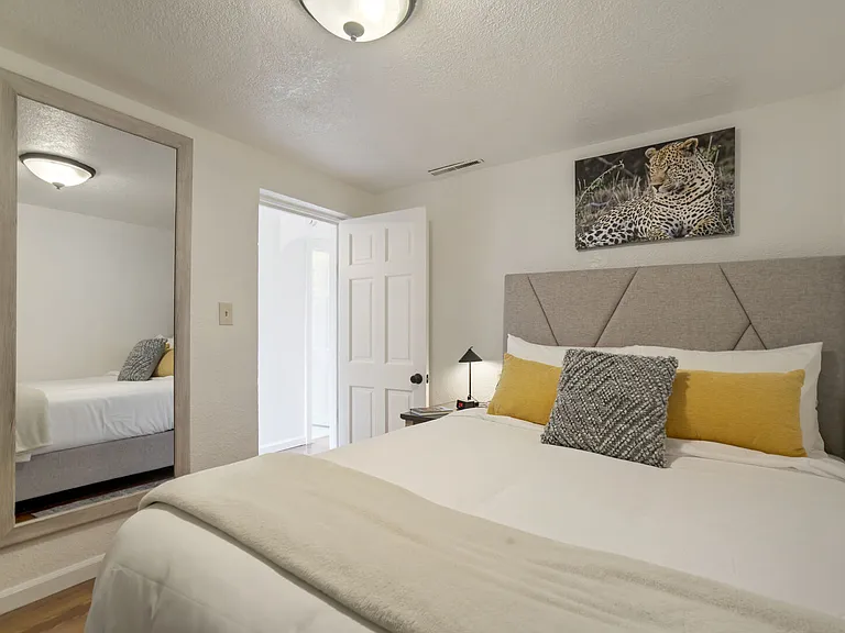 Comfortable queen bed with fresh linens and soft lighting_perfect for winding down.