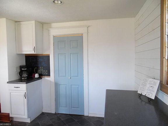 View of Kitchen with Door to first floor laundry.