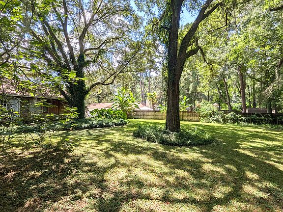 Huge, private, shaded back yard with no neighbors behind.