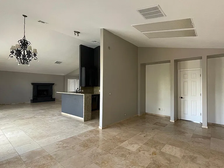 UNFURNISHED. Angle captures TV room, living, dining, kitchen and office space.