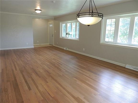 Professionally refinished hardwood floors in the large living room.  Hard-coat plaster work, neutral color palette, ceramic tile