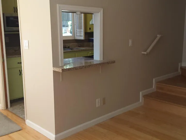 kitchen with open wall to kitchen view. Stair lead to 2nd floor