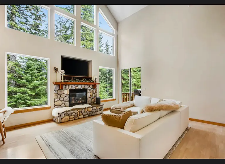 large living room with 26' ceilings and built in propane fireplace
