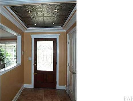 Foyer with stamped tin ceiling with pin halogen li