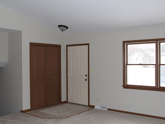 Looking at front door from the middle of the living room. Kitchen is behind and 2nd living room is down the stairs to the left.
