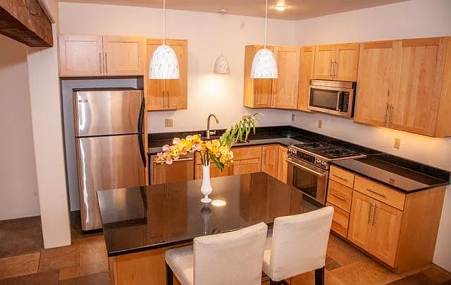Lovely kitchen with granite-topped island, built-in microwave and dishwasher, gas range, tons of cabinets and large pantry (not shown) - all perfect for entertaining.