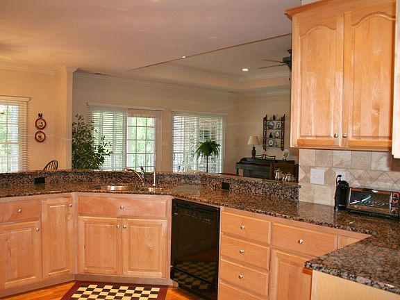 Open and airy, kitchen has dbl ovens,wood floor,granite c-tops&tile backsplash