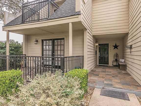 View of exterior front, two balconies, spacious slate tile entrance way