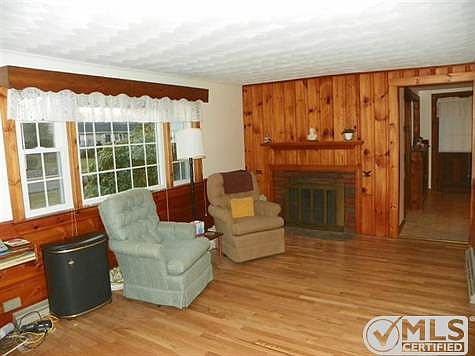Livingroom with gleaming hardwood floors and fireplace.