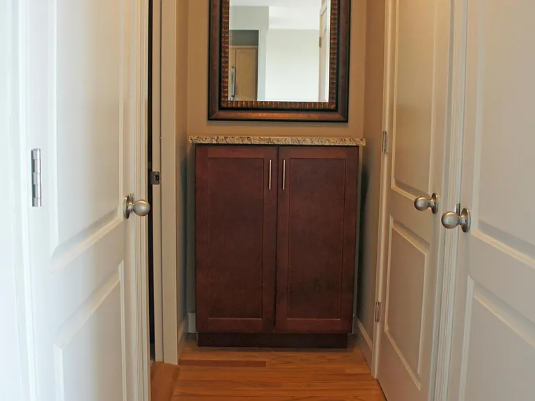 Hallway of closets and built-in storage.
