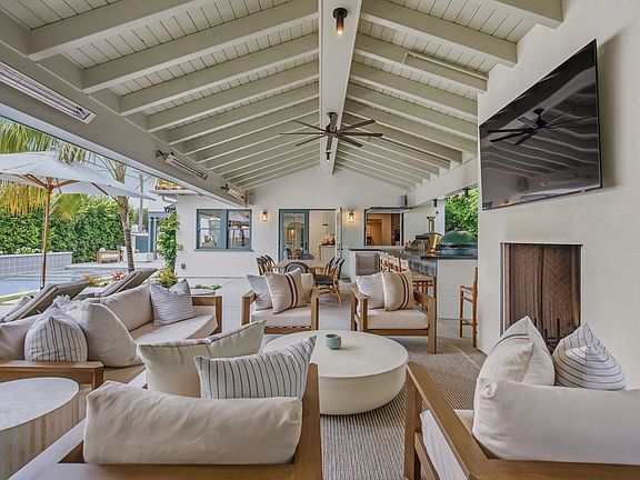 Outdoor living area complete with TV, fireplace and dining