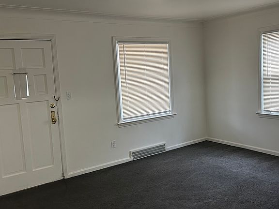 Spacious living area with natural light and clean, neutral finishes throughout.