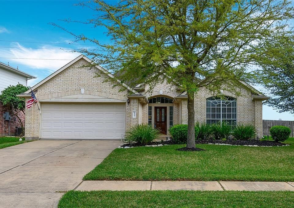 Welcoming home with crisp, clean, light brick. Plentiful natural light around door and well maintained yard. Front door freshly re-stained!