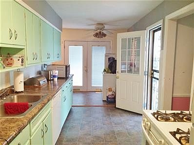 Kitchen with separate eating area and french doors to backyard.