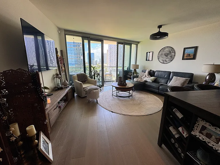 Open livingroom with large full wall sliding glass doors to lanai