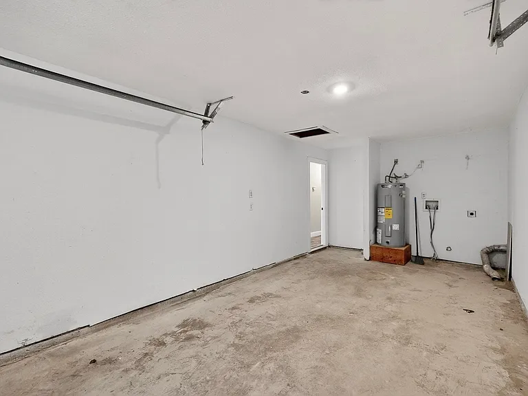 Garage featuring electric water heater