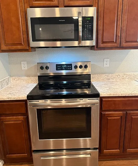 Smooth top electric range and built-in microwave/vent hood