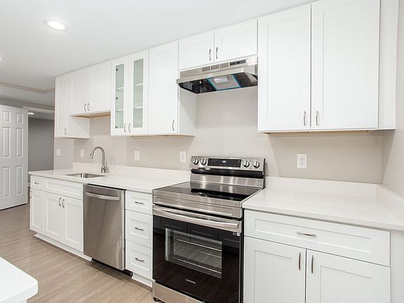 Stainless appliances and quartz countertops. Range is 30" wide, electric.