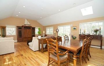 Family room features vaulted ceilings and a dining area