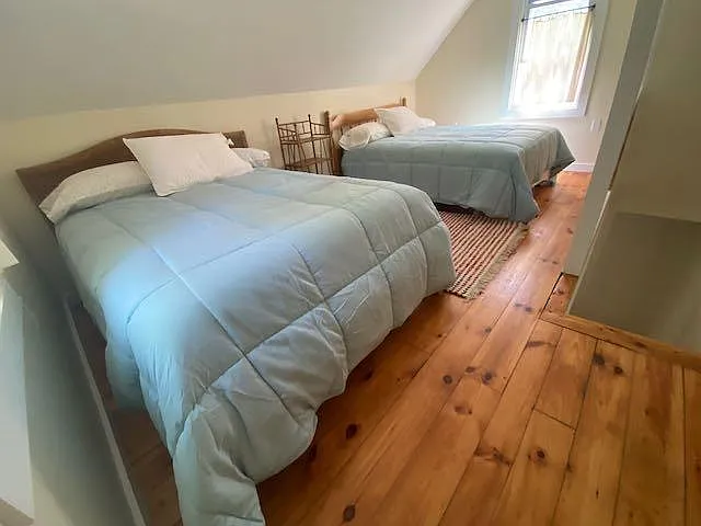 Upstairs bedroom has two double beds.