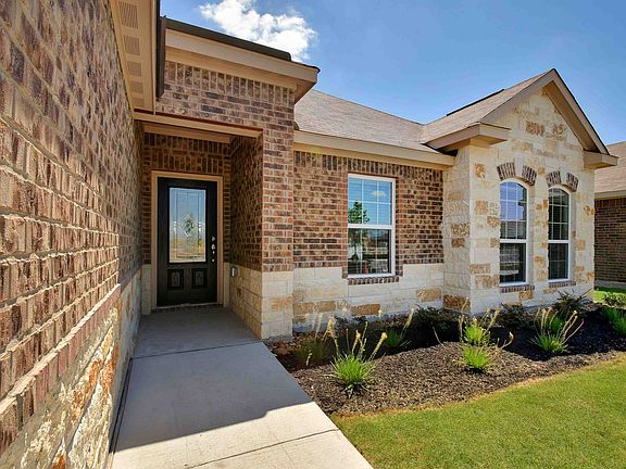 Beautiful brick and stone exterior with a fully landscaped front yard.