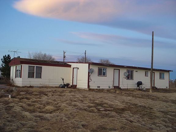 Back of the house with entrances to the work shop and back hall way