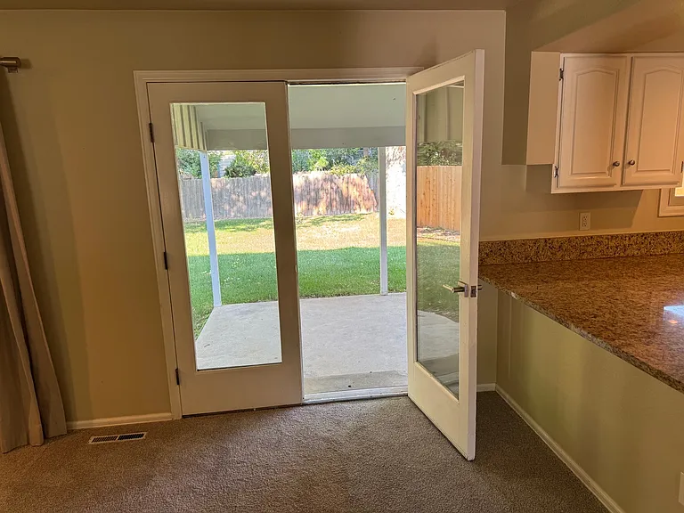 Double doors out to the back patio and yard