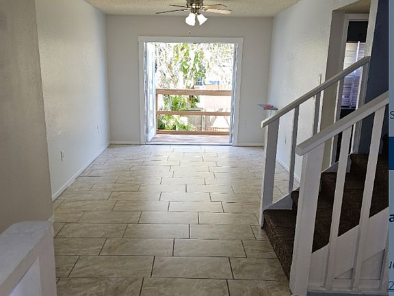 Living room features double, built-in-blinds, French doors that open to the two-level cedar wood deck and fenced backyard.