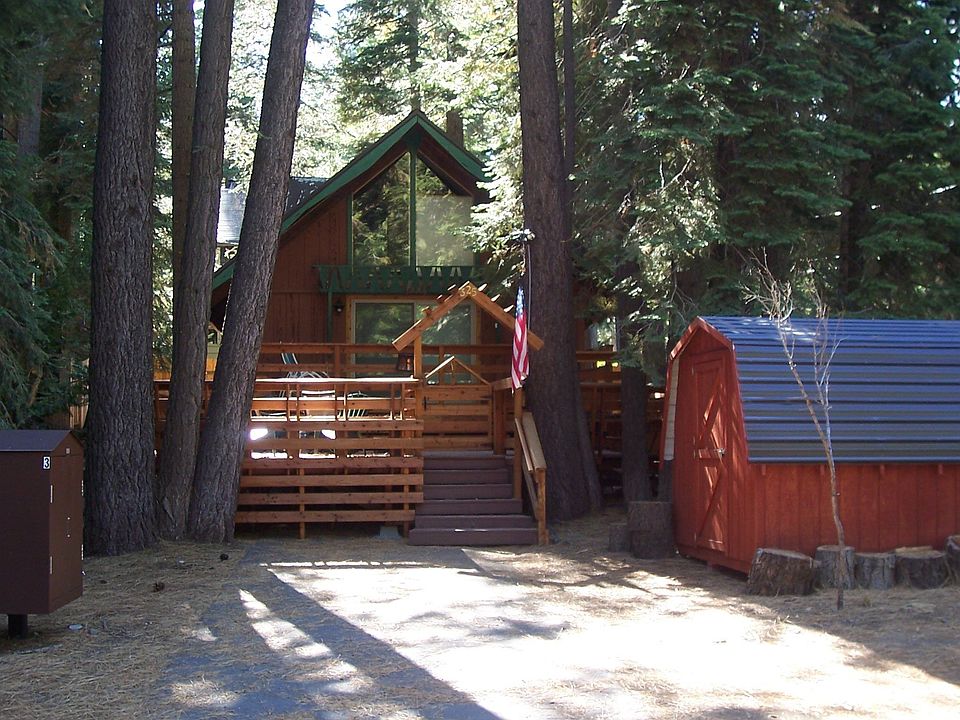 view from street entering driveway offers parking and storage shed