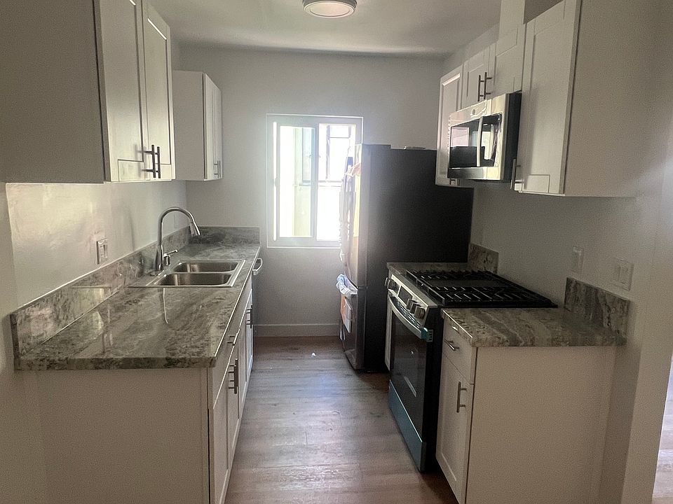 Brand new kitchen with state of the art appliances and dishwasher, storage cabinets, and plenty of light