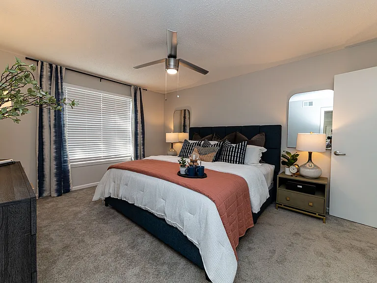 Cozy bedroom with carpet & overhead lighting