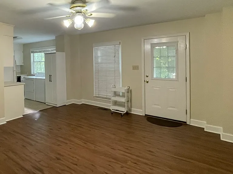 Living room, and entry door view, taken from Hallway. Apartment has lots of natural light.