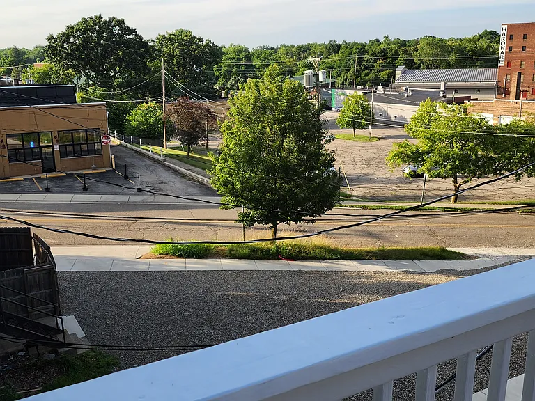 Northeast view from balcony deck, looking at the public parking lot across the street.