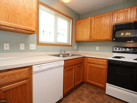 Sunny kitchen with a window over the sink looking to the back yard.