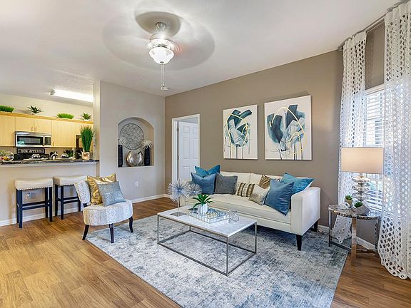 You'll love our open floor plan concepts including spacious living rooms with wood-style flooring and a ceiling fan.