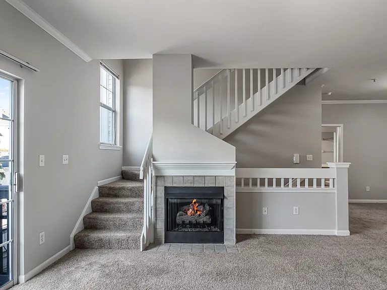 Make yourself at home in a comfortable living space featuring a cozy fireplace.
