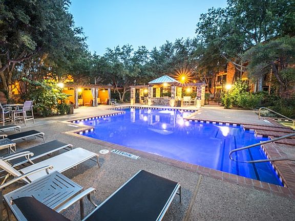 Beautiful pool with private cabanas, ceiling fans to stay co