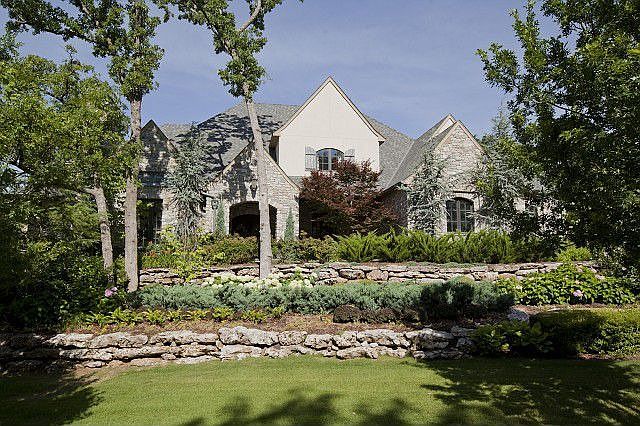 Exquisite custom stone chateau on wooded acreage!