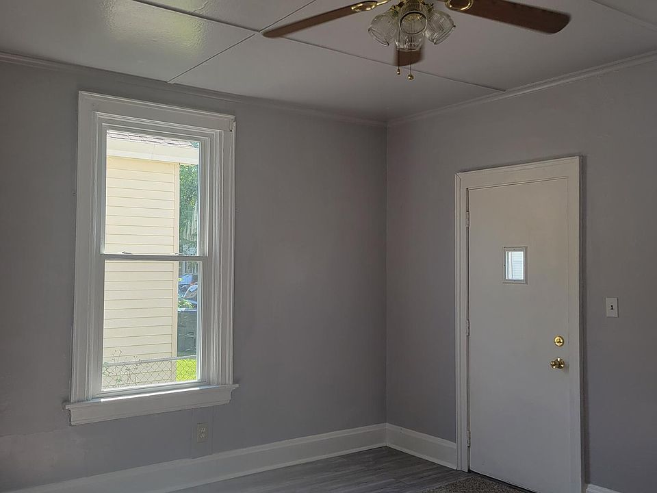 1st Floor Living room with new paint, plank flooring and windows