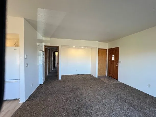 looking at entrance of apartment on right, hall to bedrooms on left
