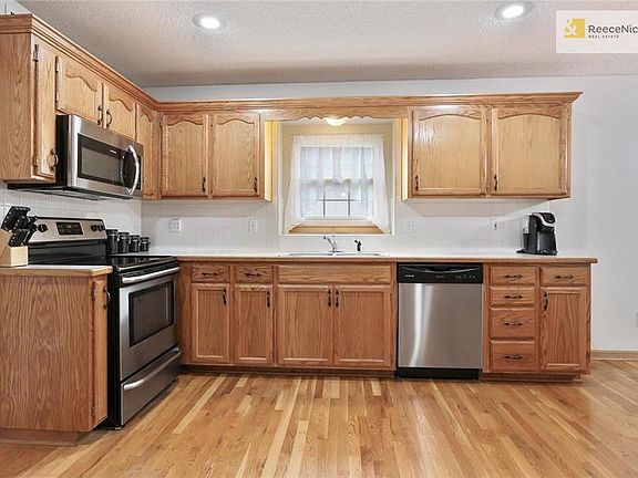 Kitchen with beautiful cabinets and newer S/S appliances that remain with the property.