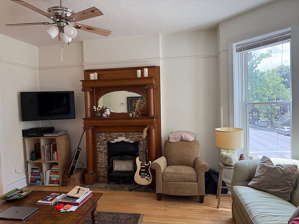 living room w/ bay windows and built-in fireplace