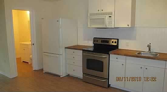 Kitchen with dishwasher, fridge and stove.