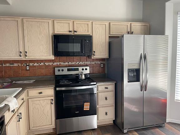 Kitchen with new stove and new refrigerator